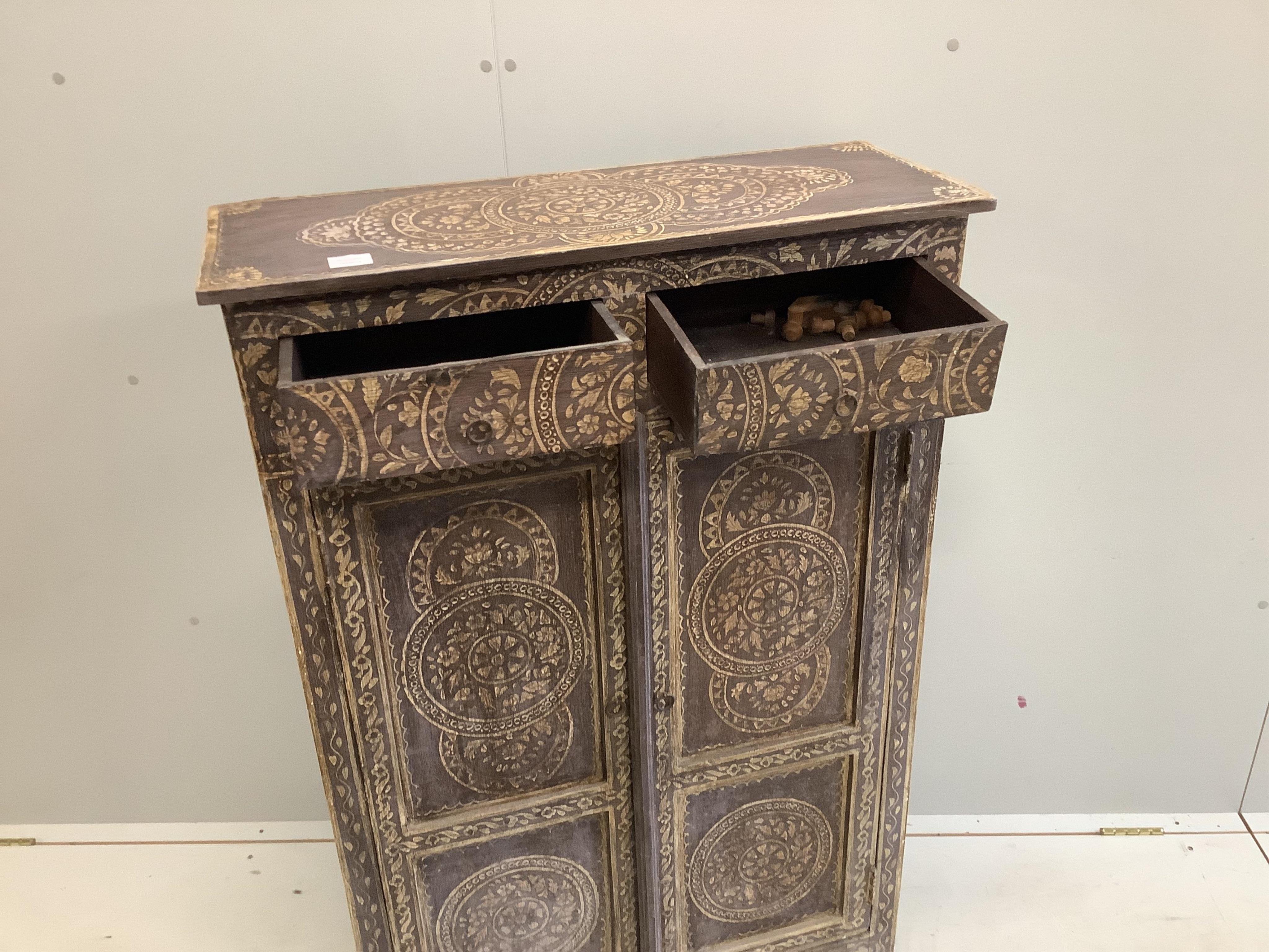 An Indian painted two door side cabinet, width 81cm, depth 32cm, height 122cm. Condition - fair